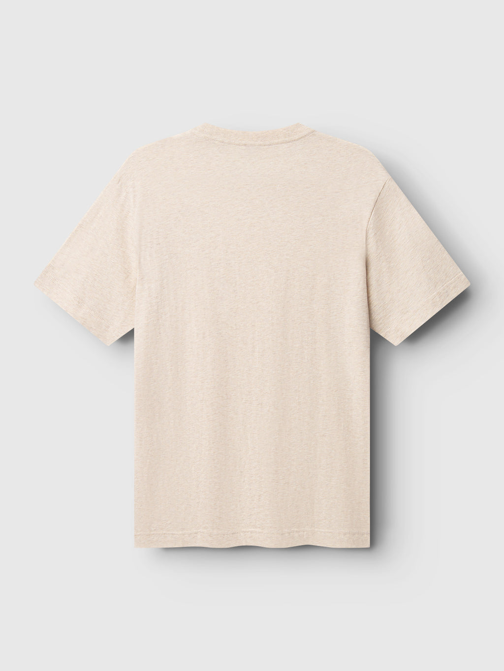 The Gabba Dune Melange SS T-shirt in Lt. Sand, crafted from ultra-soft melange jersey fabric, features a simple, casual design with short sleeves. Displayed on a light gray background from the back, it offers a plain beige look.