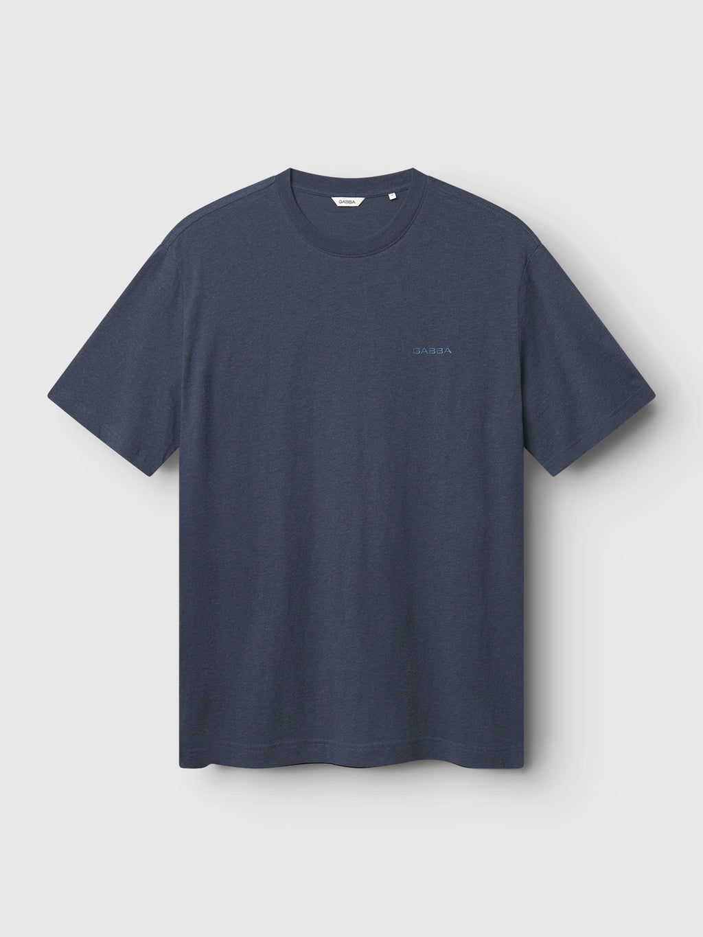 The Gabba Dune Melange SS in Navy Mel. is a plain, dark blue T-shirt with short sleeves and a round neckline, made from ultra-soft melange jersey featuring subtle text on the chest, hanging against a light gray background.