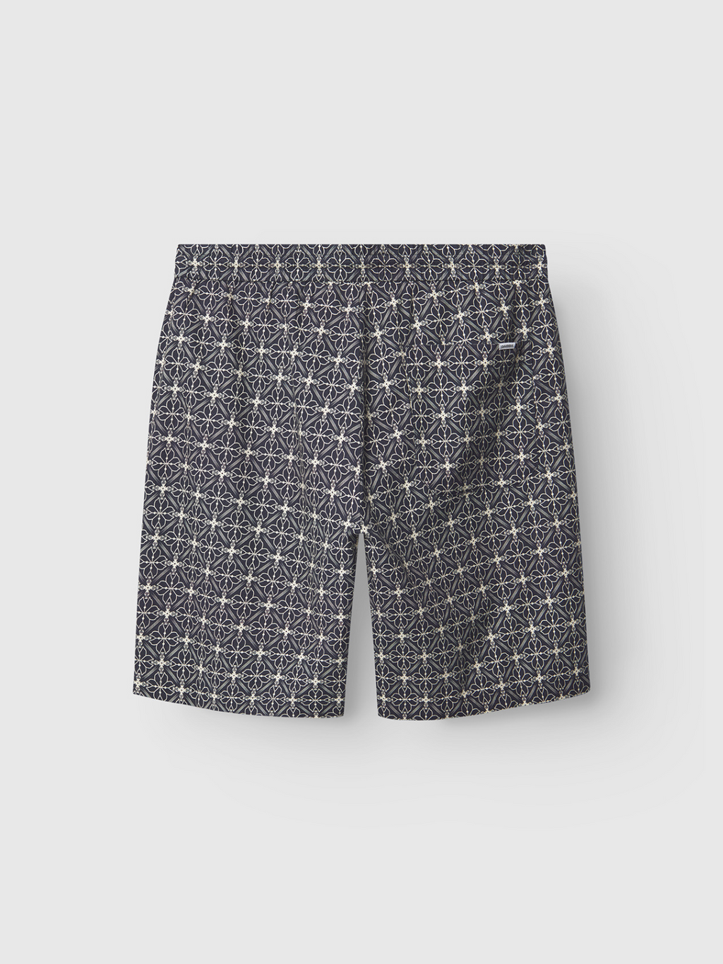 The Gabba Tommi AOP - Navy shorts are crafted from 100% cotton in navy, showcasing a detailed white geometric star pattern, displayed flat on a plain white background.