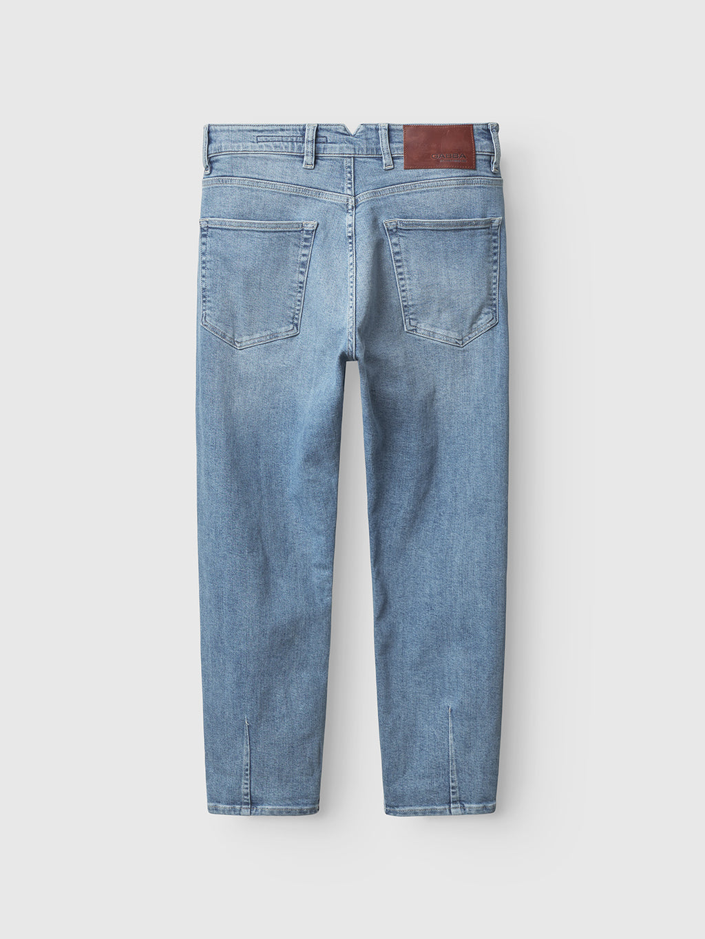 The back view of Gabbas Alex Foursix Limited Lt. Blue Denim jeans features a fashion-forward design with large back pockets and a brown leather patch on the waistband, laid flat against a plain white background.