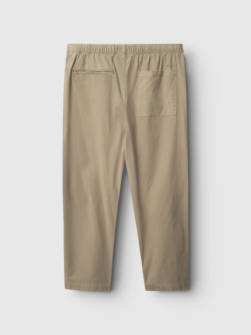 Gabbas Topgun Jash pants in sand feature a beige elastic waistband, ripstop fabric, and two back pockets (one with button closure). Displayed on a light grey background, these pants offer a simple and casual style.