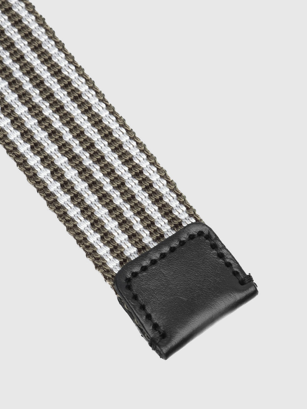 The Manica Belt by Gabba features intricate stitching on its black leather end, with alternating green and white woven stripes. This high-quality belt contrasts elegantly with a plain white background.