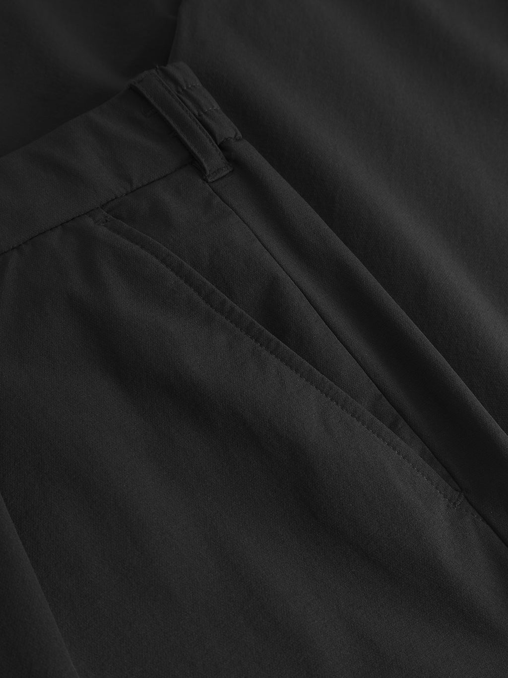 Close-up of a pair of Gabbas Napoli 19 Tech - Black pants, showcasing the pocket and waistband. The smooth, matte fabric enhances its clean, versatile design ideal for both comfort and style.