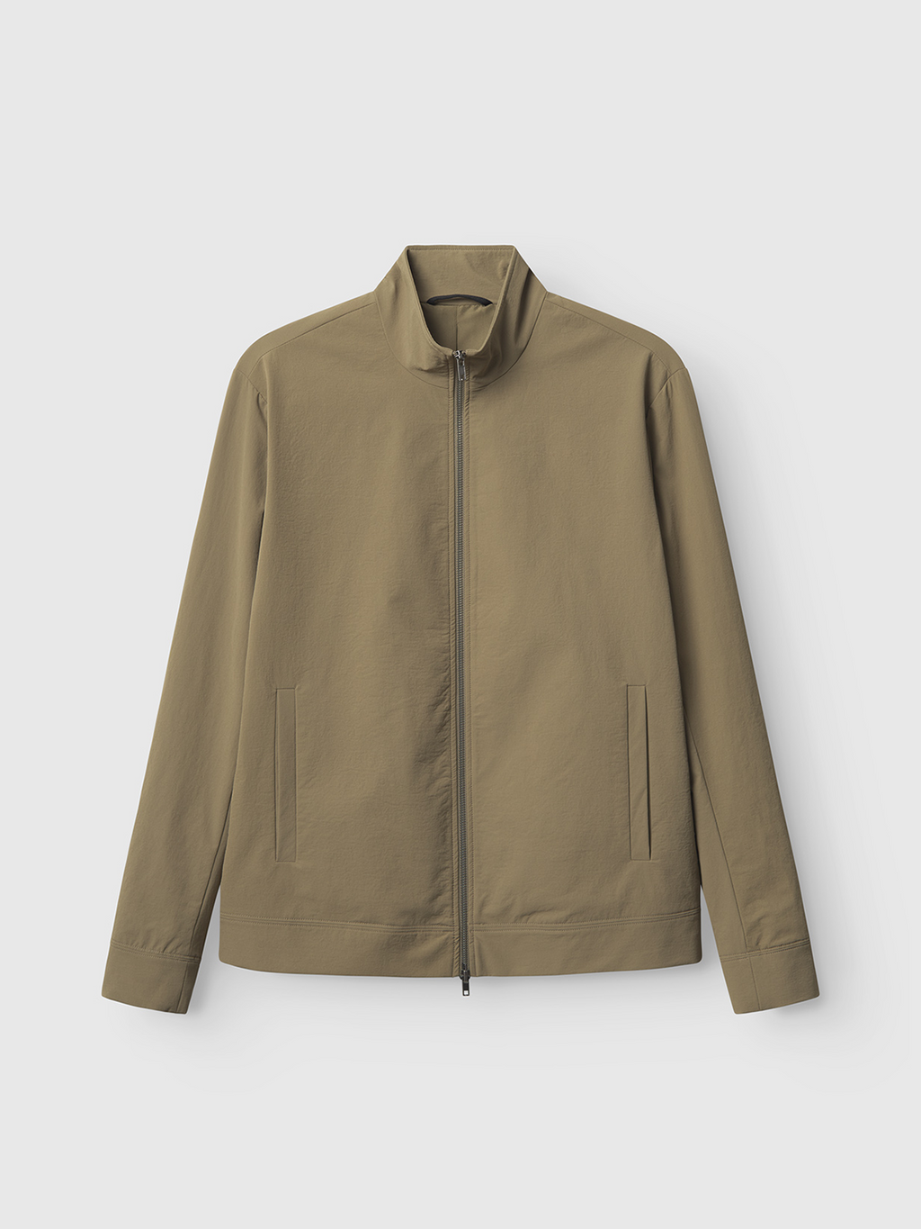 The Gabba Nik Tech - Army jacket in olive green features a high collar and zip front closure, designed for an on-the-go lifestyle with tech material. It has two vertical side pockets and is showcased against a light gray background.