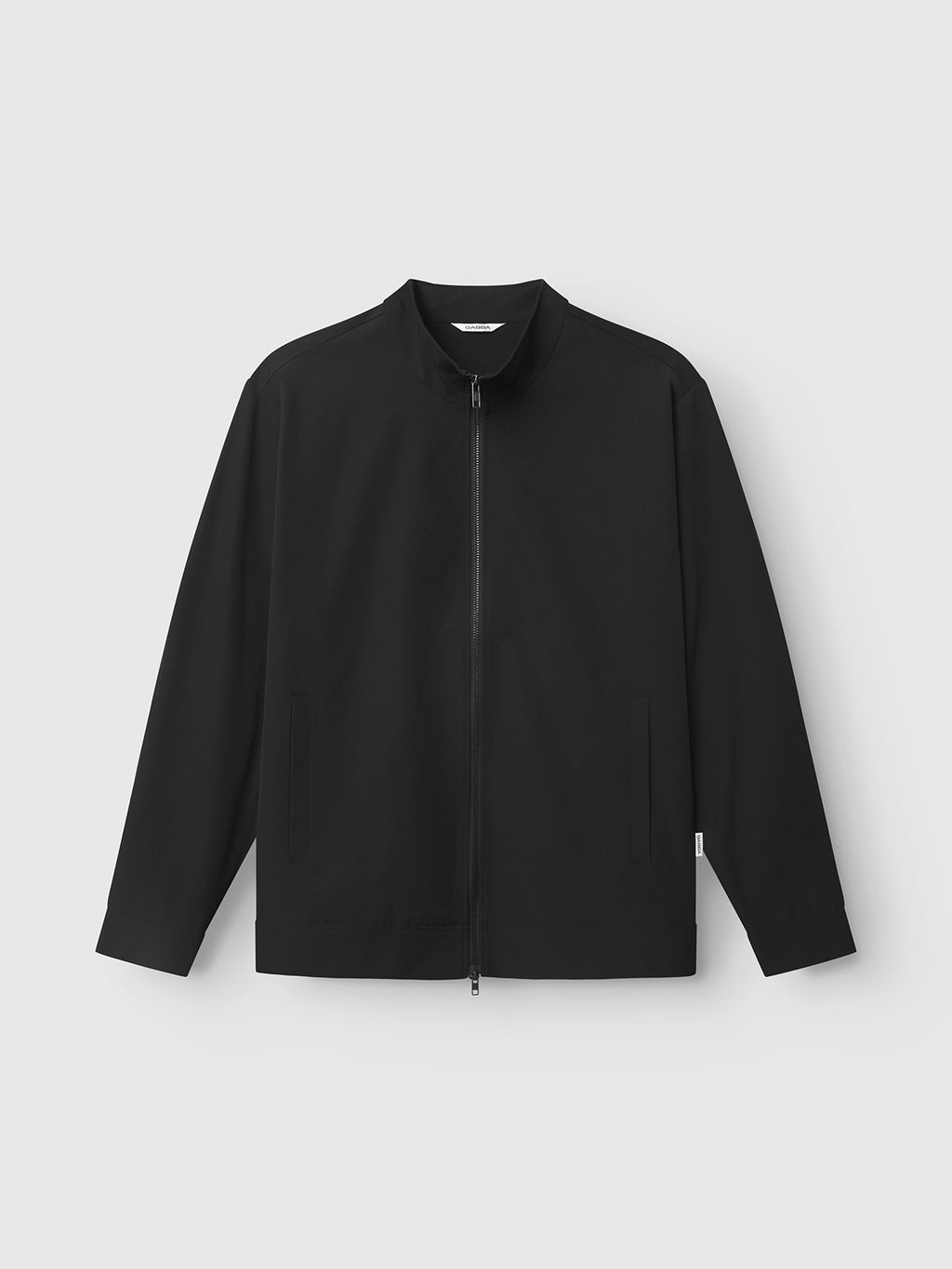 The Gabba Nik Tech - Black is a long-sleeve, zip-up jacket with a stand collar, shown on a plain light gray background. It features two front pockets and a sleek, unbranded design for modern practicality.