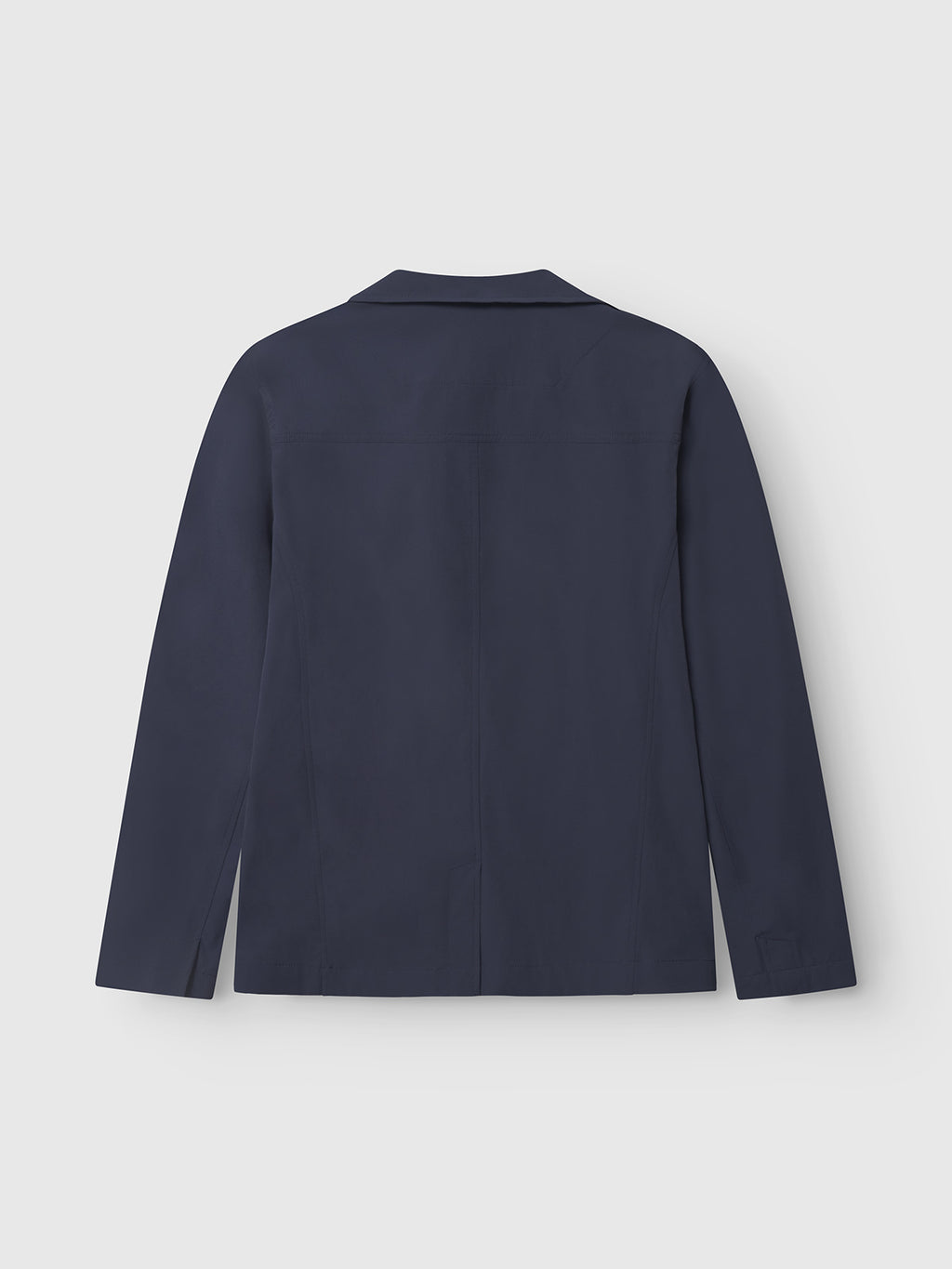 A rear shot of the Gabba Plaza Tech - Navy blazer, designed with long sleeves and a tailored fit, showcasing spacious pockets set against a light gray background.