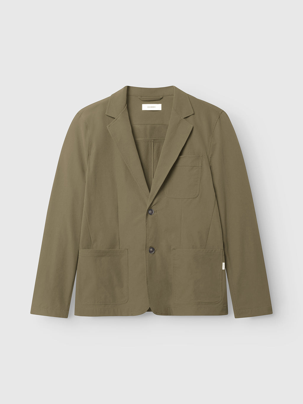 The Plaza Tech - Army by Gabba is an olive green blazer featuring notched lapels, a two-button closure, and a tailored fit. It includes three spacious front patch pockets and is displayed on a plain white background.