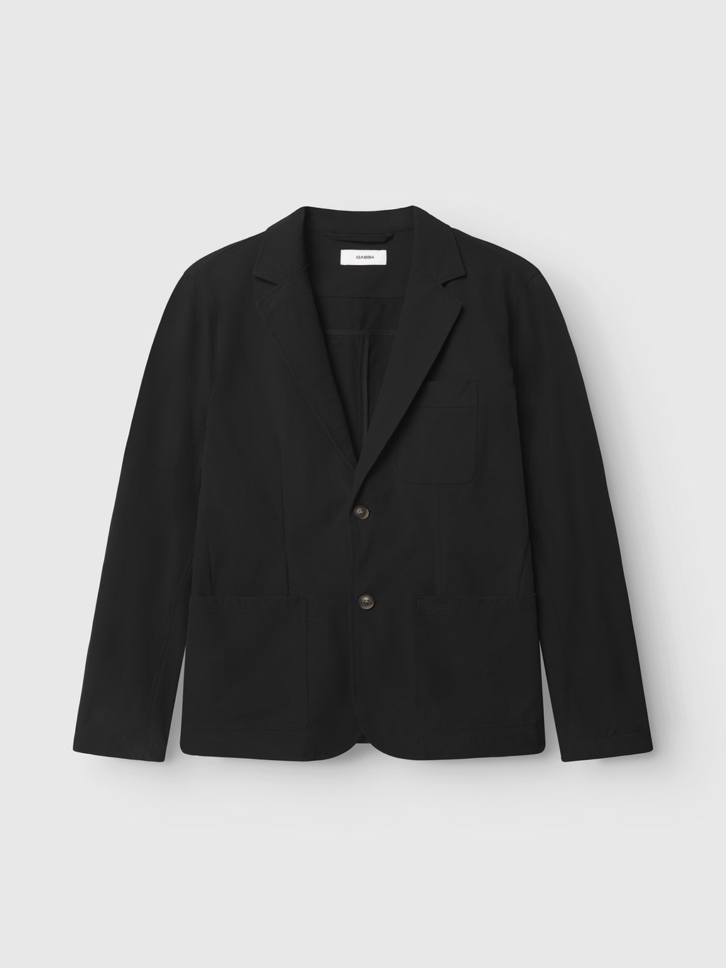 Set against a light gray background, the Gabba Plaza Tech - Black is a tailored black tech blazer featuring two buttons, spacious pockets, and notched lapels. Ideal for formal or semi-formal events.