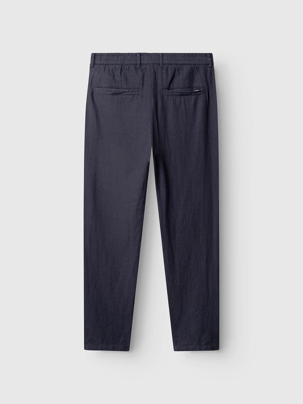The Gabba Monza Lino Cropped - Night Sky pants are shown from the back, featuring an elastic waist, two welt pockets—including one with a zipper—for added comfort and style.