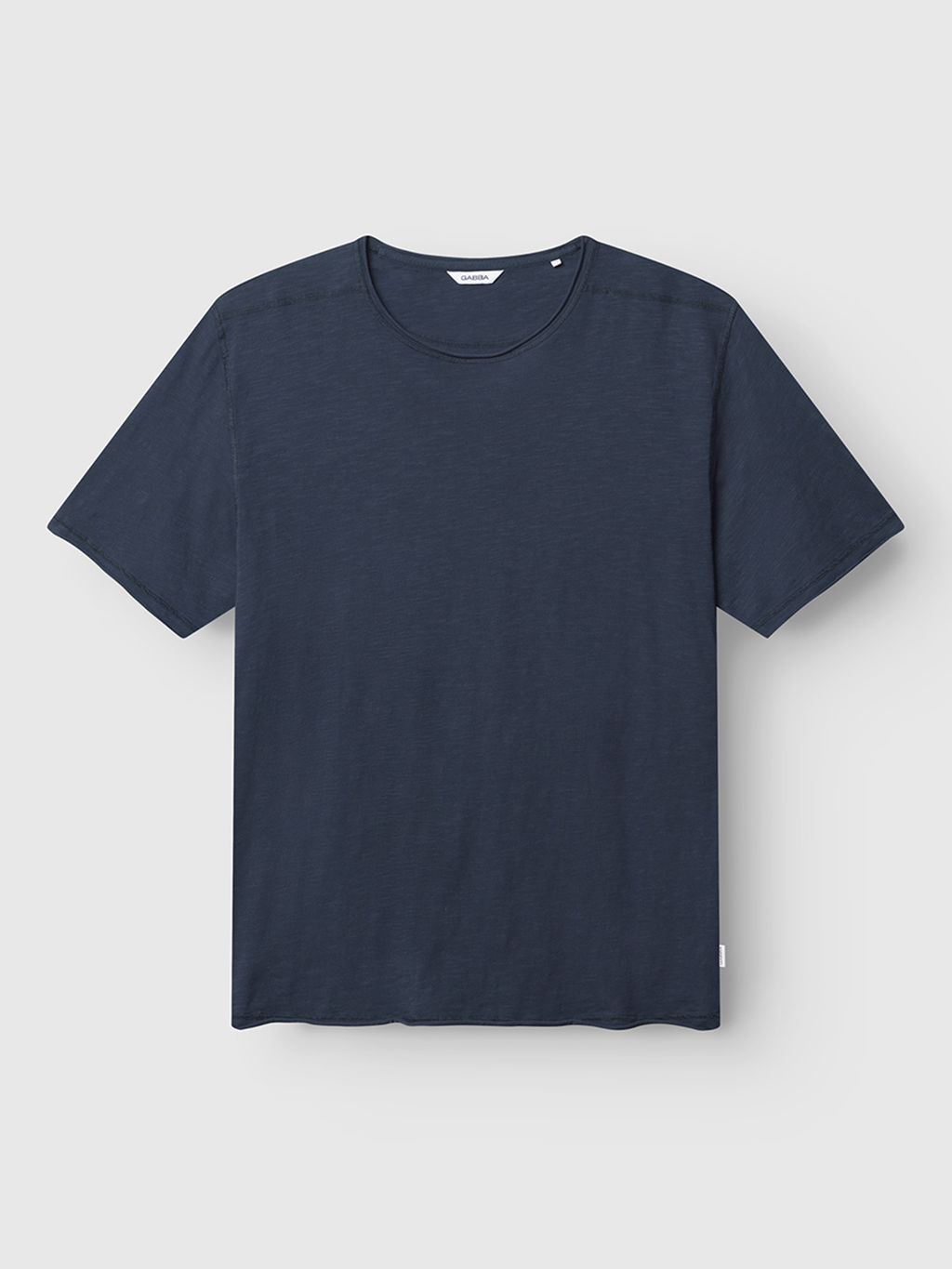 The Gabba Kostant New SS in navy is a regular-fit, short-sleeved T-shirt with a classic crew neck and no visible logos or patterns, shown laid flat on a light gray background.