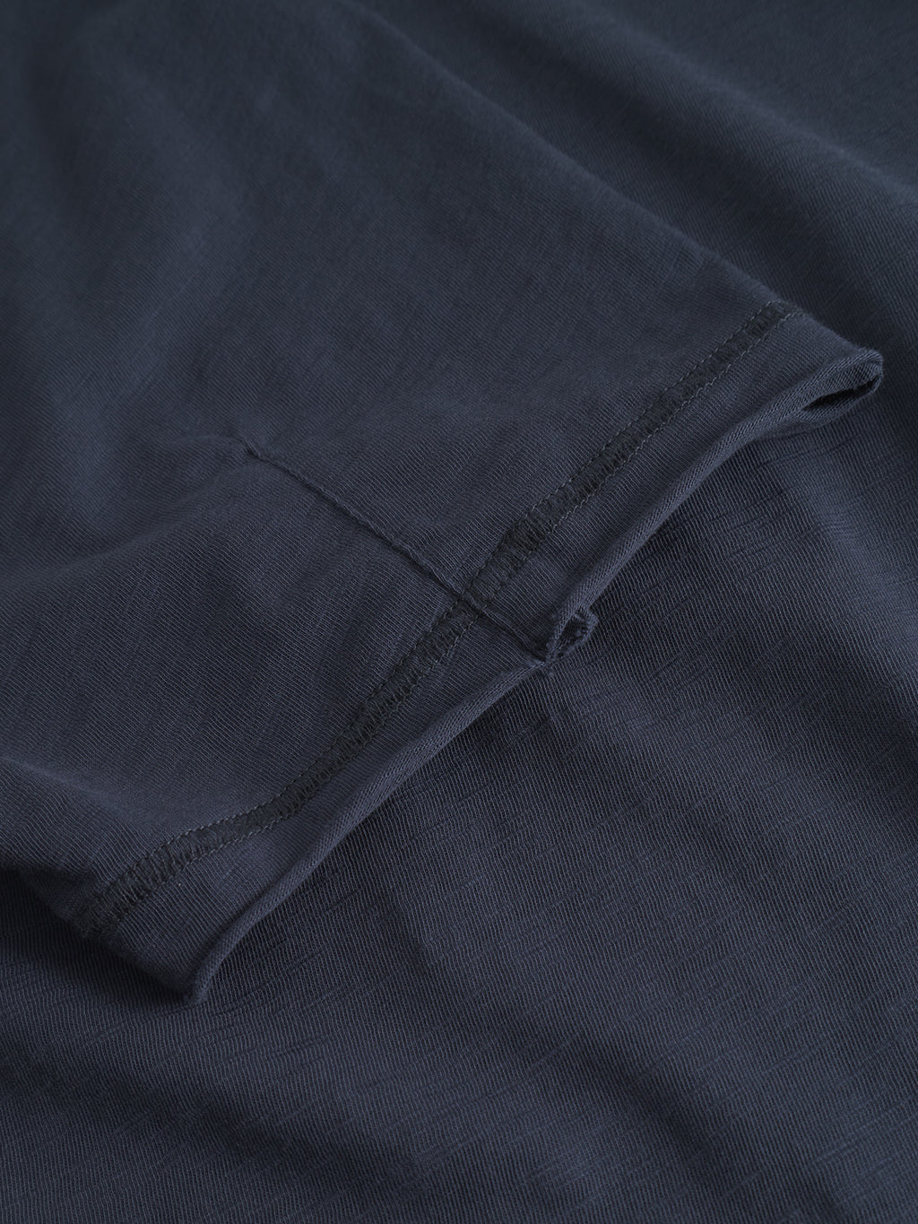 A close-up of the Kostant New SS - Navy t-shirt by Gabba, showcasing the flatlock stitch and textured fabric for a relaxed fit.