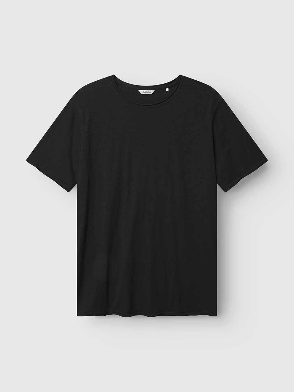 The Gabba Kostant New SS - Meteorite is a plain black slub fabric T-shirt with a classic crew neckline, relaxed fit, and minimalist design, shown against a light gray background.