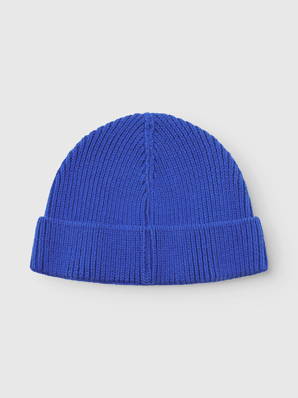 Introducing the Gabba New Mount Beanie - Blue: a vibrant blue knit hat with a ribbed design and stylish folded brim, presented on a plain light gray background.