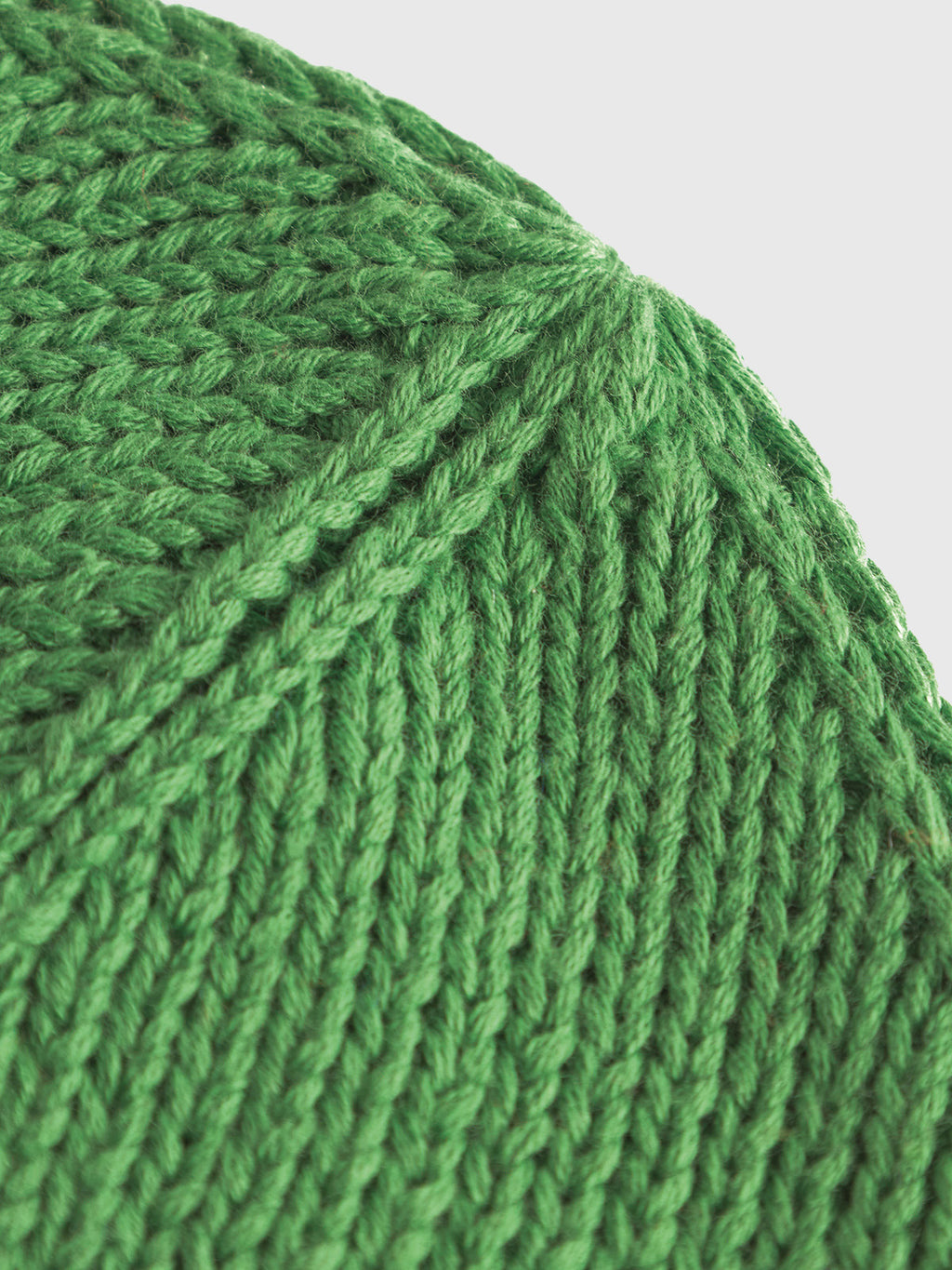 Close-up of a Gabbas New Mount Beanie - Green knitted fabric, featuring a vibrant ribbed pattern with diagonally intersecting stitches.