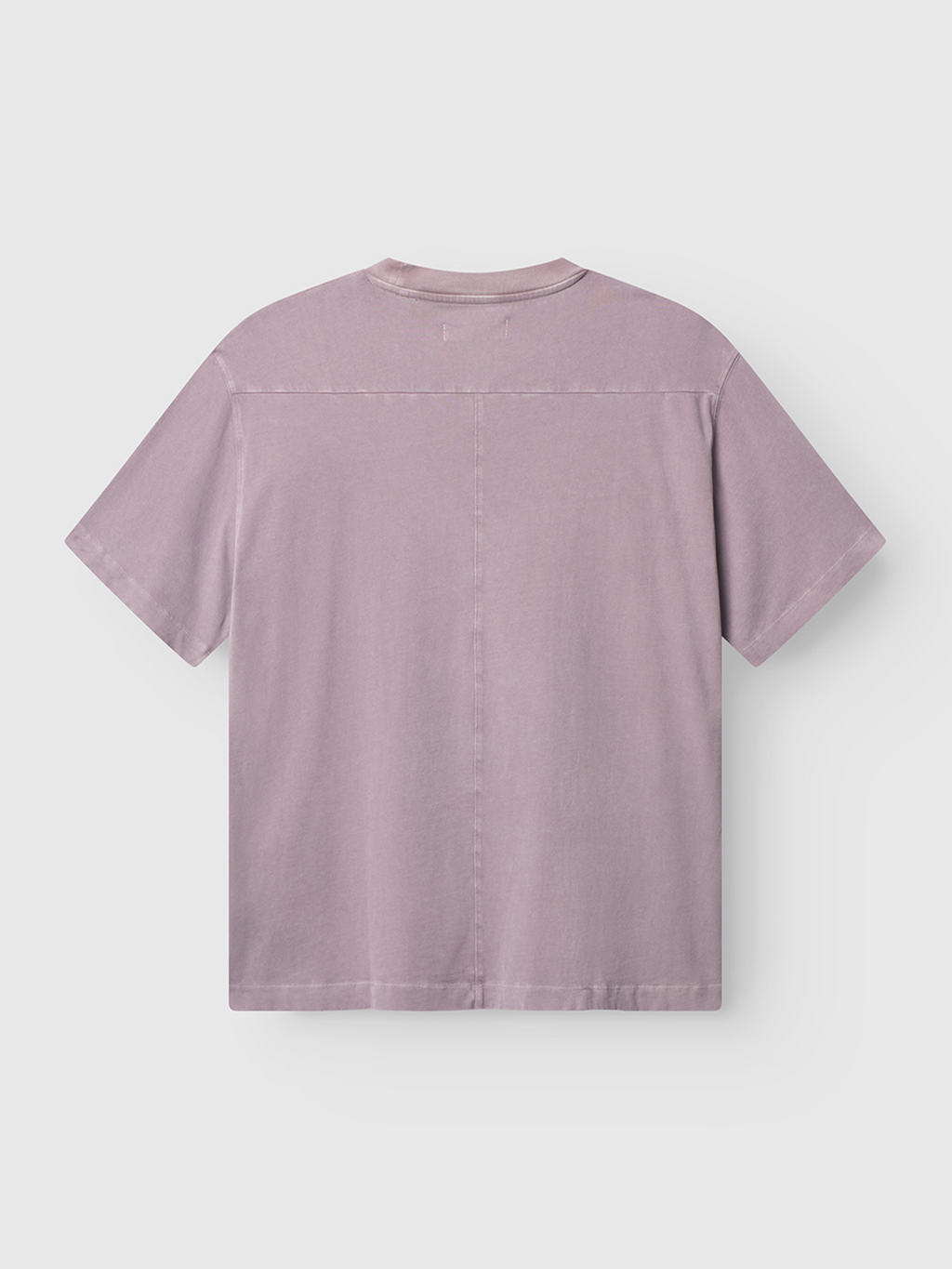 The Gabba Nigel Wix Boxy Peso SS in Dust Purple is a short-sleeved cotton jersey t-shirt, shown flat from the back. It features visible stitching, a straight hem, and a simple design.