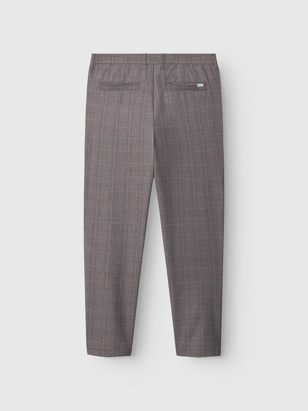 Back view of Gabba Monza Tinun - Brown Check tailored dress pants with a regular straight fit, brown check pattern, two welt pockets, and a small white label above the right pocket, shown on a light gray background.
