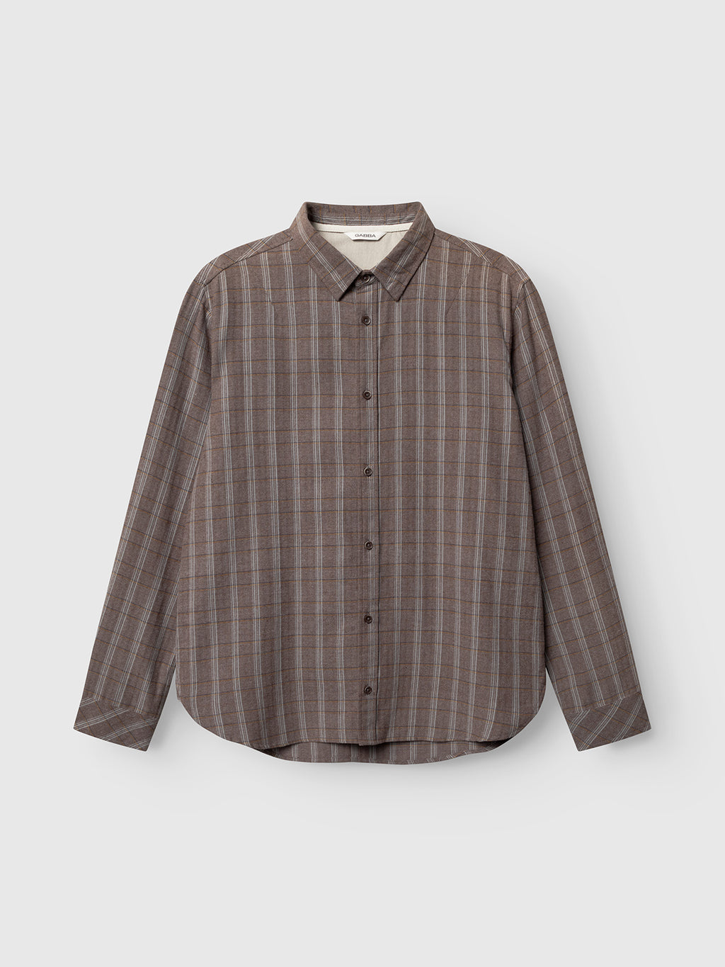 The Gabba Sven Reg Herri LS in brown rust, a long-sleeve cotton shirt with a subtle plaid pattern, classic collar, and curved hem, is displayed on a light grey background.