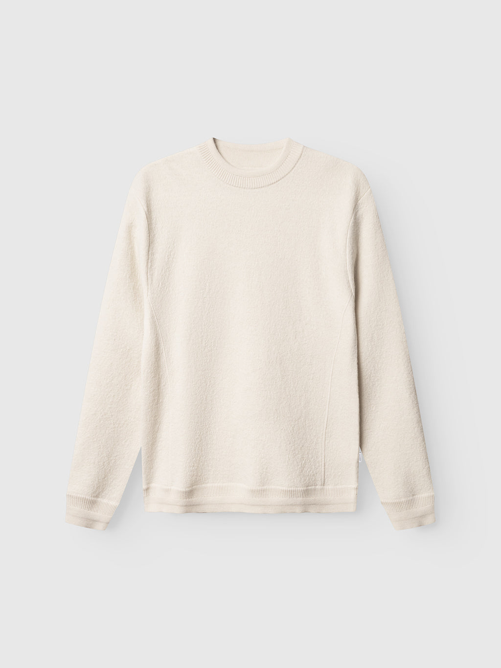The Gabba Bristol Led - White Almond is a minimalist, off-white crewneck sweater with long sleeves, made from soft textured fabric and shown flat against a light gray background.