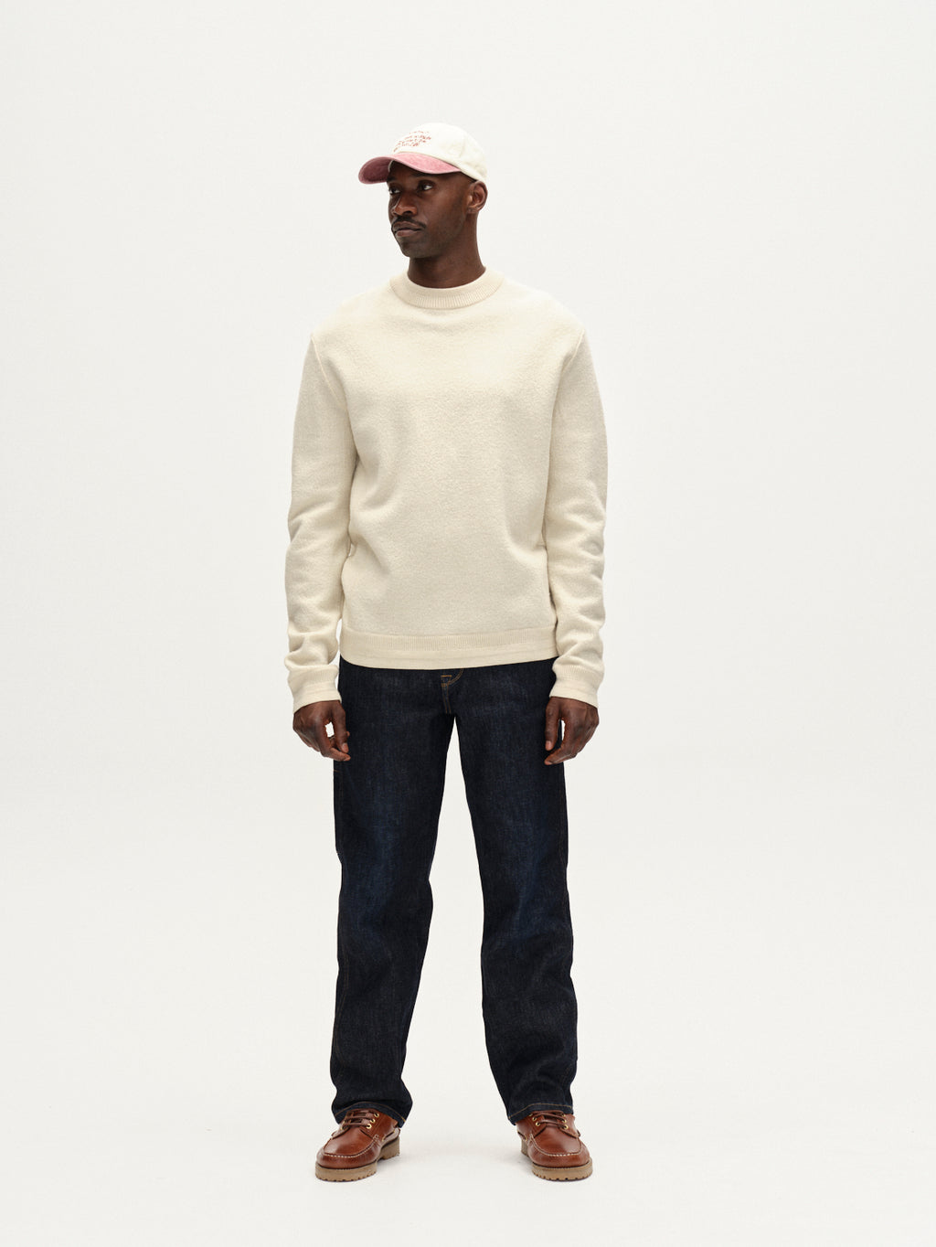 A man faces forward against a plain white background, wearing the Gabba Bristol Led sweater in White Almond.