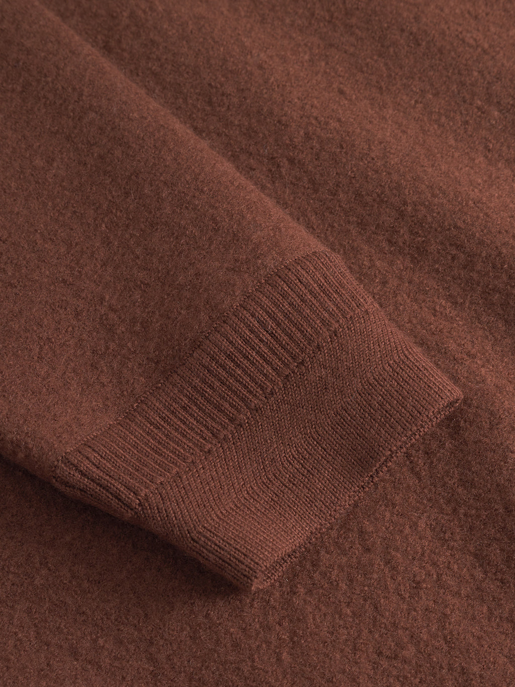Close-up of Gabba's Bristol Led - Brownish sweater, showcasing the textured wool sleeve, ribbed knit cuff, and soft, cozy fabric.