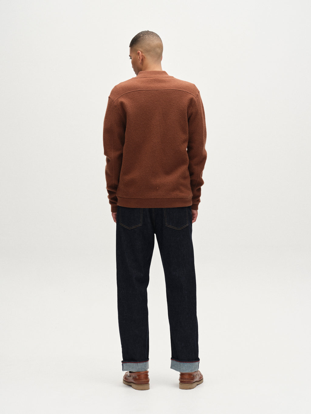 A person faces away from the camera, wearing Gabba's Cardiff Led - Brownish shirt paired with dark cuffed jeans and brown shoes, all against a plain white background.