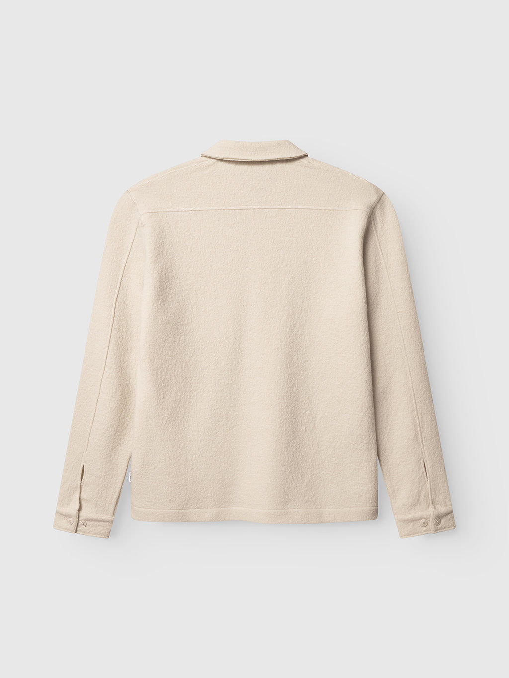 The Gabba Preston Led - White Almond is a beige, long-sleeve overshirt shown from the back with a collar, straight yoke, and buttoned cuffs. Made from soft boiled wool for a tailored look. Background is plain white.