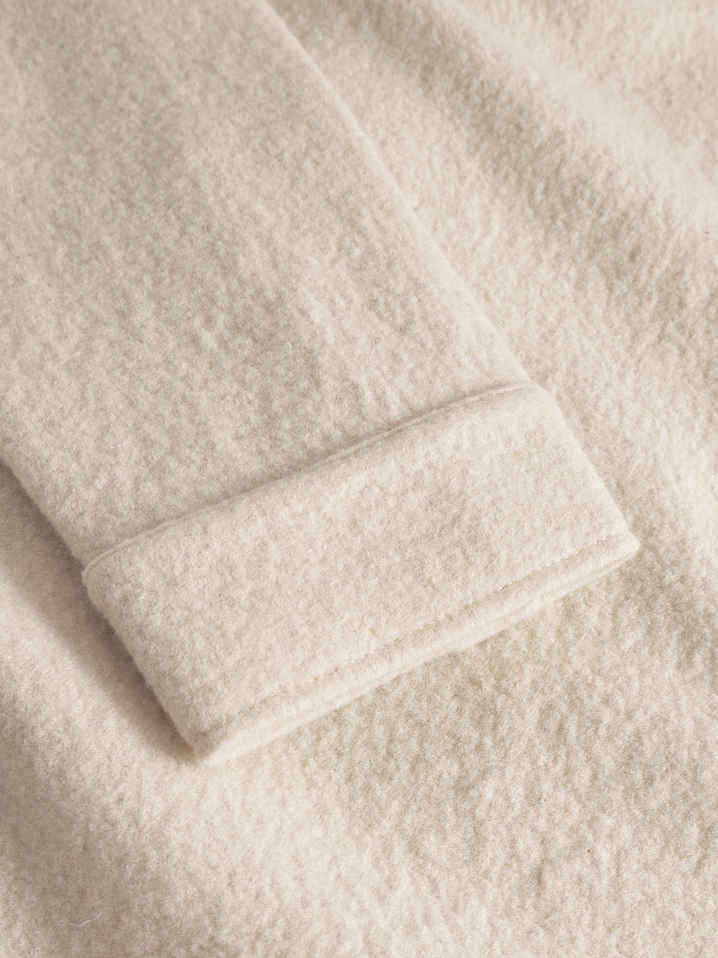 Close-up of Gabba’s Preston Led - White Almond: a soft, beige boiled wool fabric with a fuzzy texture and tailored cuff edge, likely from a coat or overshirt.