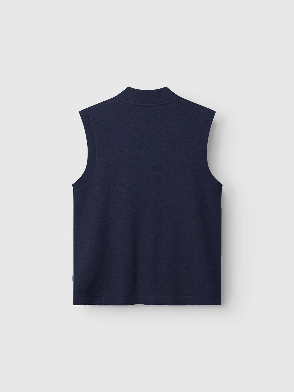 The Norwich Led - Navy vest by Gabba is a sleeveless wool piece in navy, shown laid flat and viewed from the back against a light background. Its simple, pattern-free design makes it a versatile option for layering.