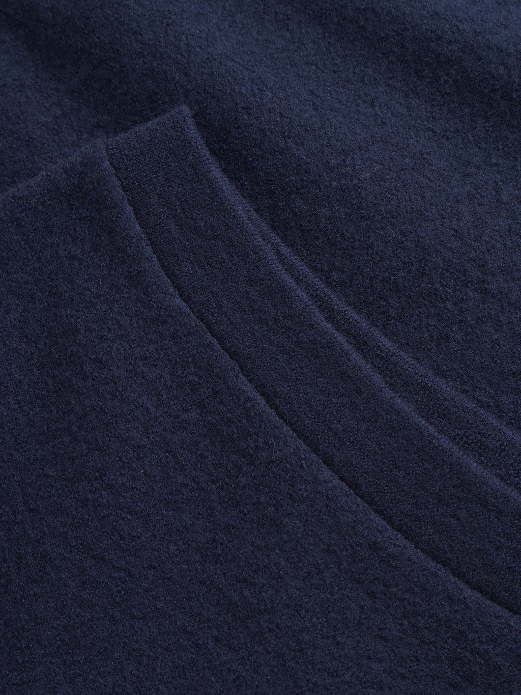 Close-up of Gabba’s Norwich Led - Navy, featuring soft, dark blue textured fabric with a visible seam and fold, ideal for layering.