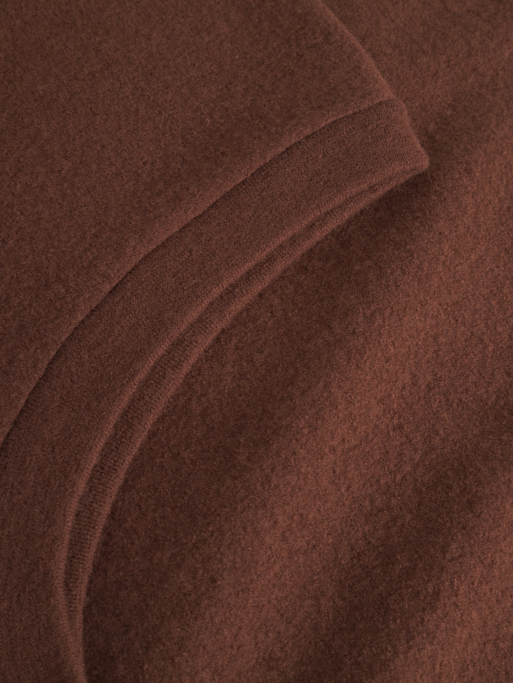 Close-up of the Norwich Led - Brownish by Gabba, highlighting the soft brown fabric, curved seam, and detailed stitching that showcase its texture—perfect as a stylish layering piece.