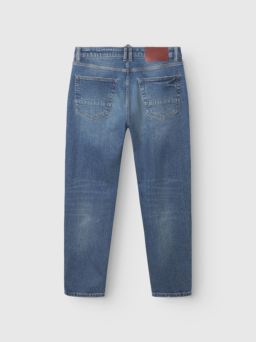 The Carl Oskin Dark Blue Denim jeans by Gabba feature a straight-leg, relaxed fit with subtle fading, two rear pockets, and a brown leather waistband patch for a casual look.
