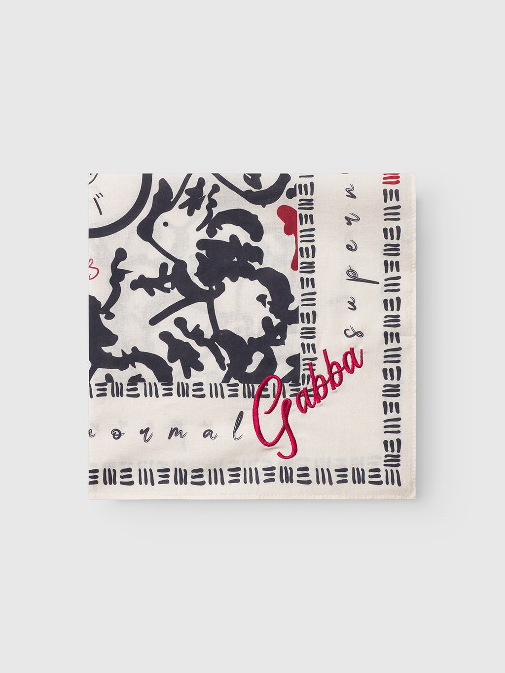 The Gabba Bandana Yovi - Multi Pattern is a cream cotton bandana with black Japanese-inspired designs, a red heart, and Gabba in red script, displayed on a light gray background.