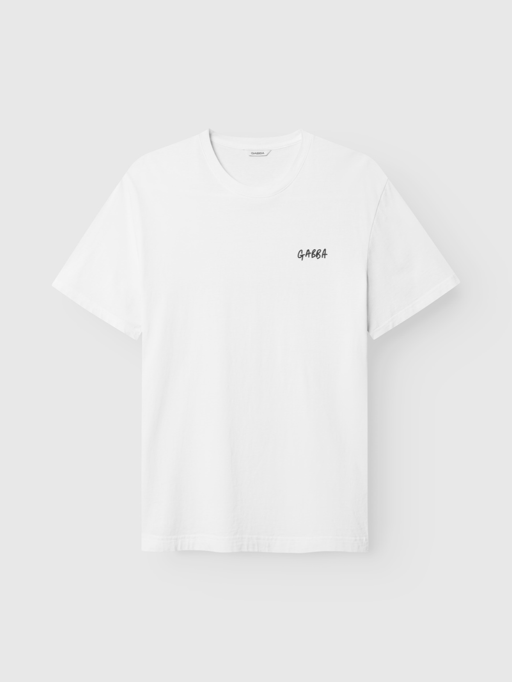 The Gabba Dune Kay Dot SS GOTS - White is an organic cotton short-sleeve T-shirt featuring a small black GAHEA print on the left chest, subtly referencing the Gabba x Kay collaboration.