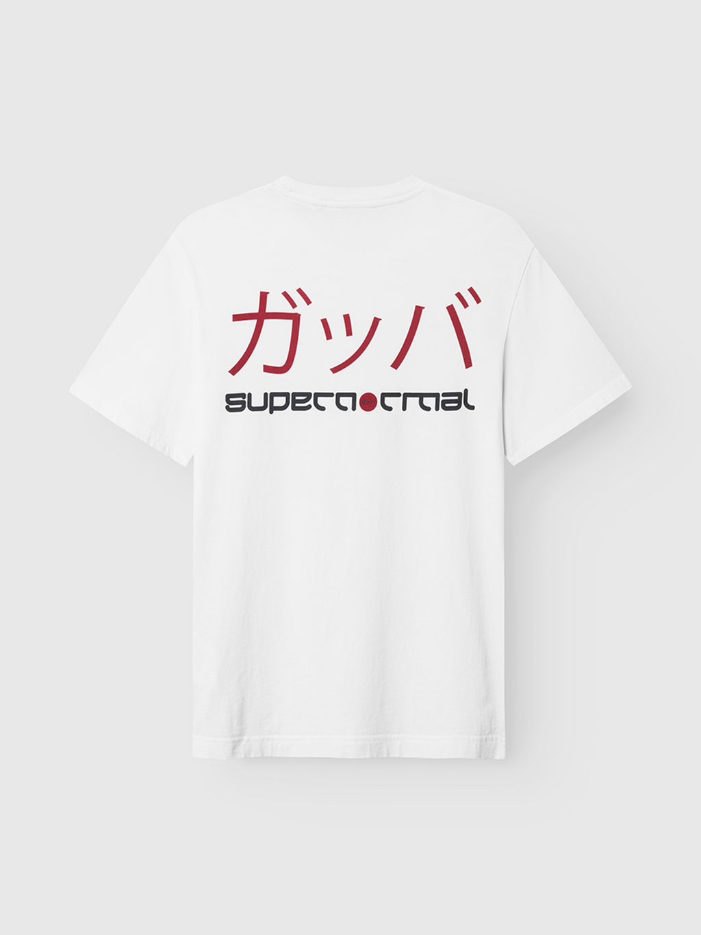 The Gabba Dune Kay Dot SS GOTS - White is an organic cotton tee with bold red Japanese katakana and the SUPERNORMAL motif in black and red on the back—a striking piece from the Gabba x Kay collaboration.