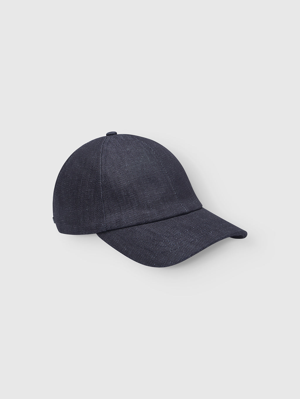 The Gabba Sity Self Cap in dark denim features a plain design, curved brim, and is made from recycled fibers, shown against a light gray background.