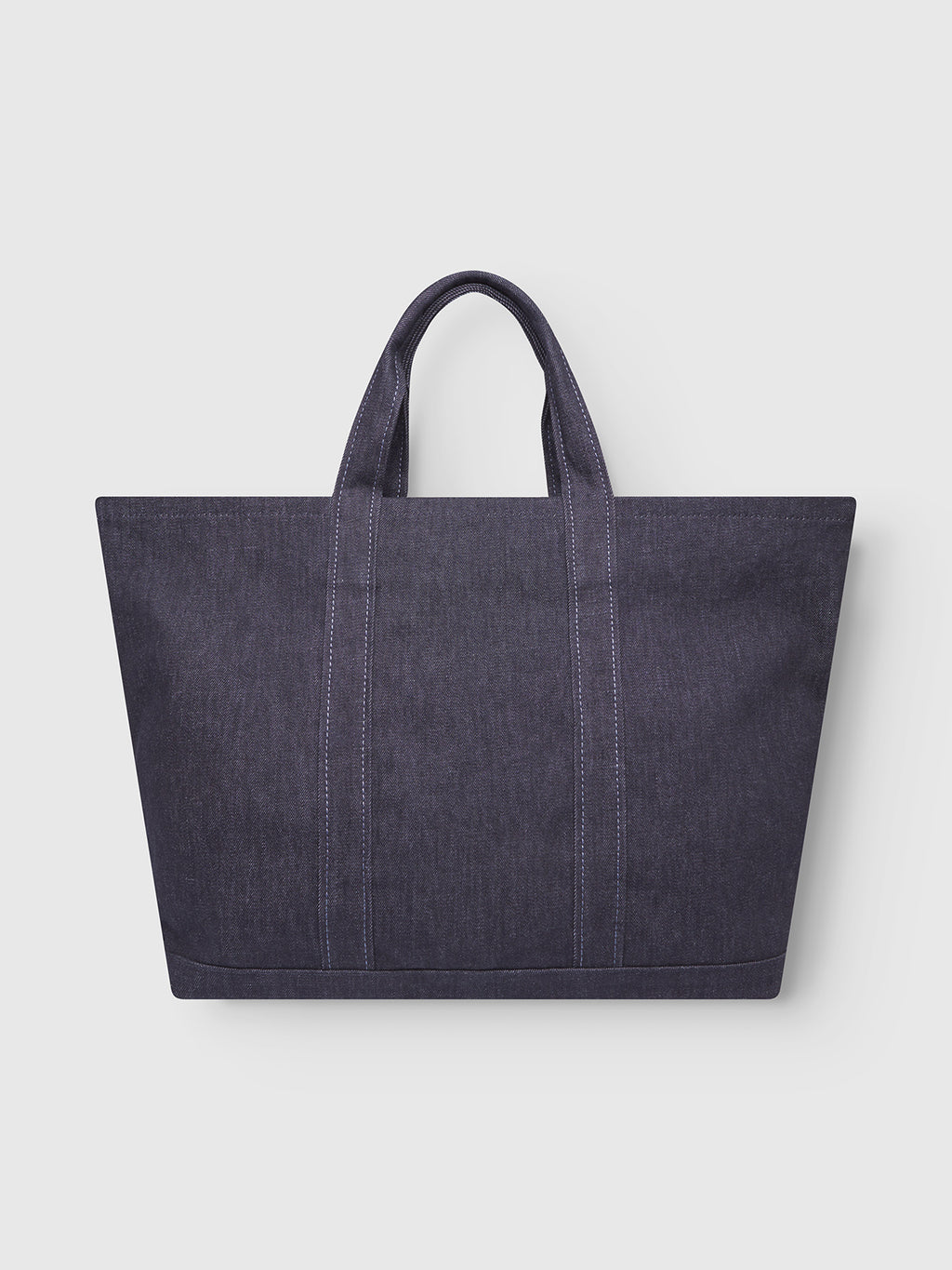 The Bag Self - Dark Blue Denim by Gabba is a rectangular tote made from recycled fibers, featuring two short handles and visible stitching, shown against a plain light gray background.