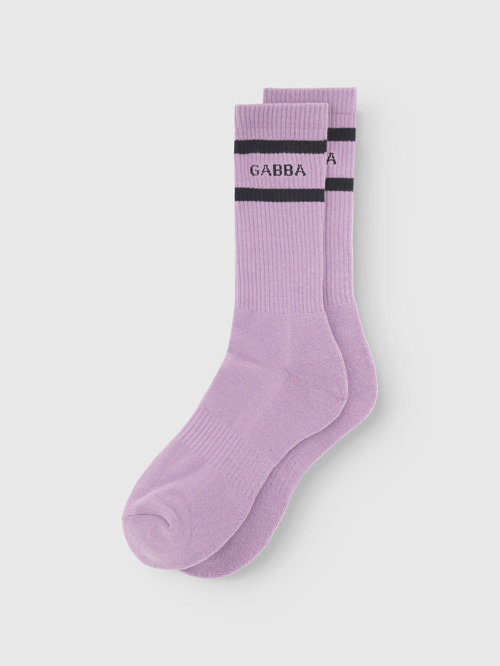The Gabba Zino Socks in Dust Purple feature black stripes near the top and GABBA printed below. Made from breathable cotton, these crew socks are displayed neatly on a plain white background.