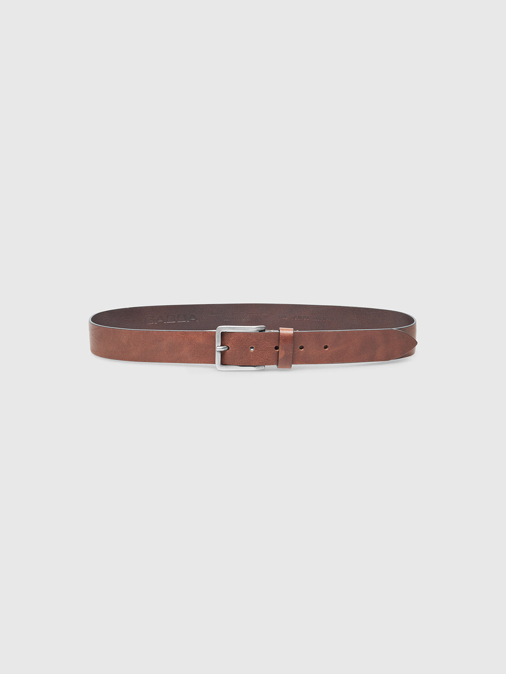 The Gabba Talia Belt in cognac features genuine leather and a silver rectangular buckle, shown flat on a light gray background—a versatile accessory for any wardrobe.