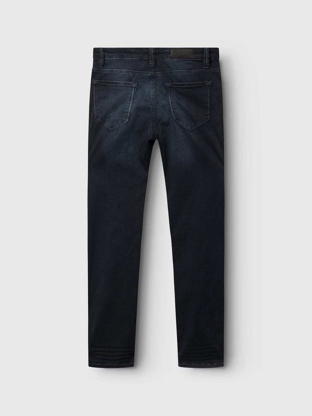Rear view of Jones K2291 - Denim wash by GABBA, a dark blue slim silhouette jeans against a light gray background. These jeans feature reinforced pockets, subtle fading, and straight legs.