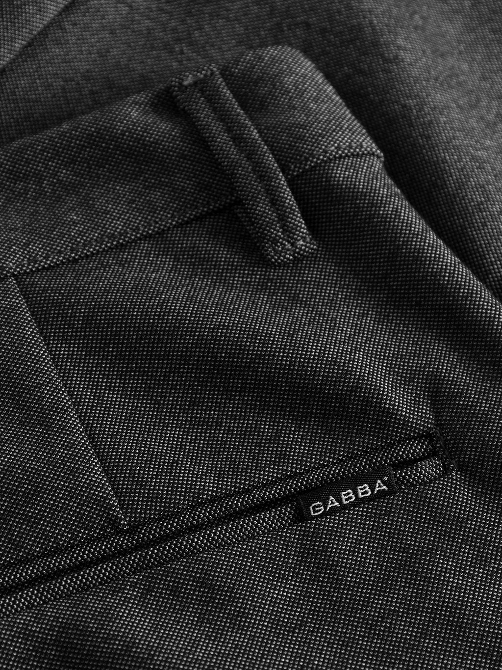 Close-up of grey mel textured Pisa Jersey Pant by GABBA, offering a metro look with visible pocket detailing. Made from high-stretch fabric for comfort, these stylish trousers feature a tapered fit and have the label GABBA sewn near the pocket.