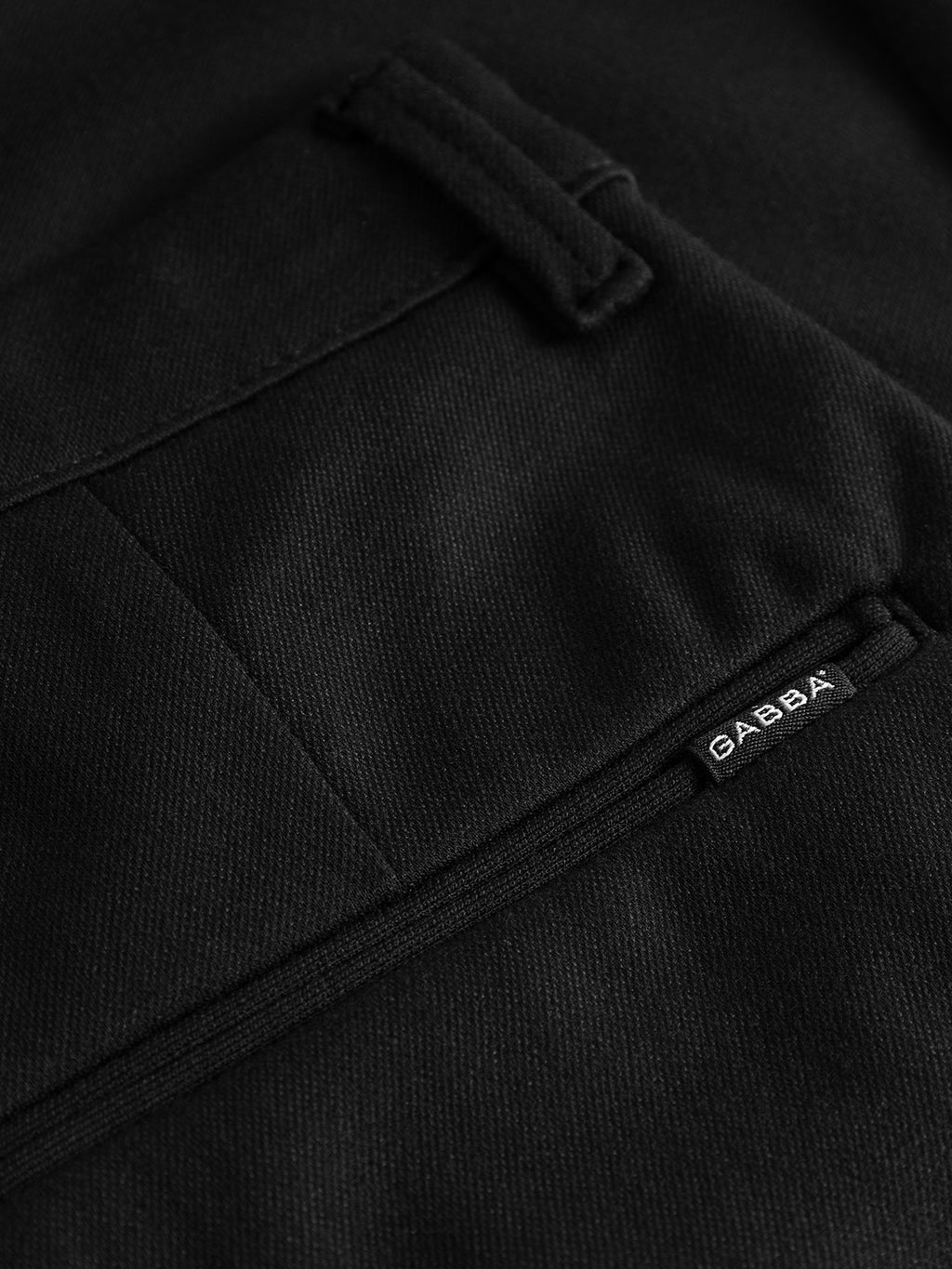 Close-up of the Pisa Jersey Pant - Black, featuring a sleek high-stretch fabric pocket with the GABBA label for a metro look.