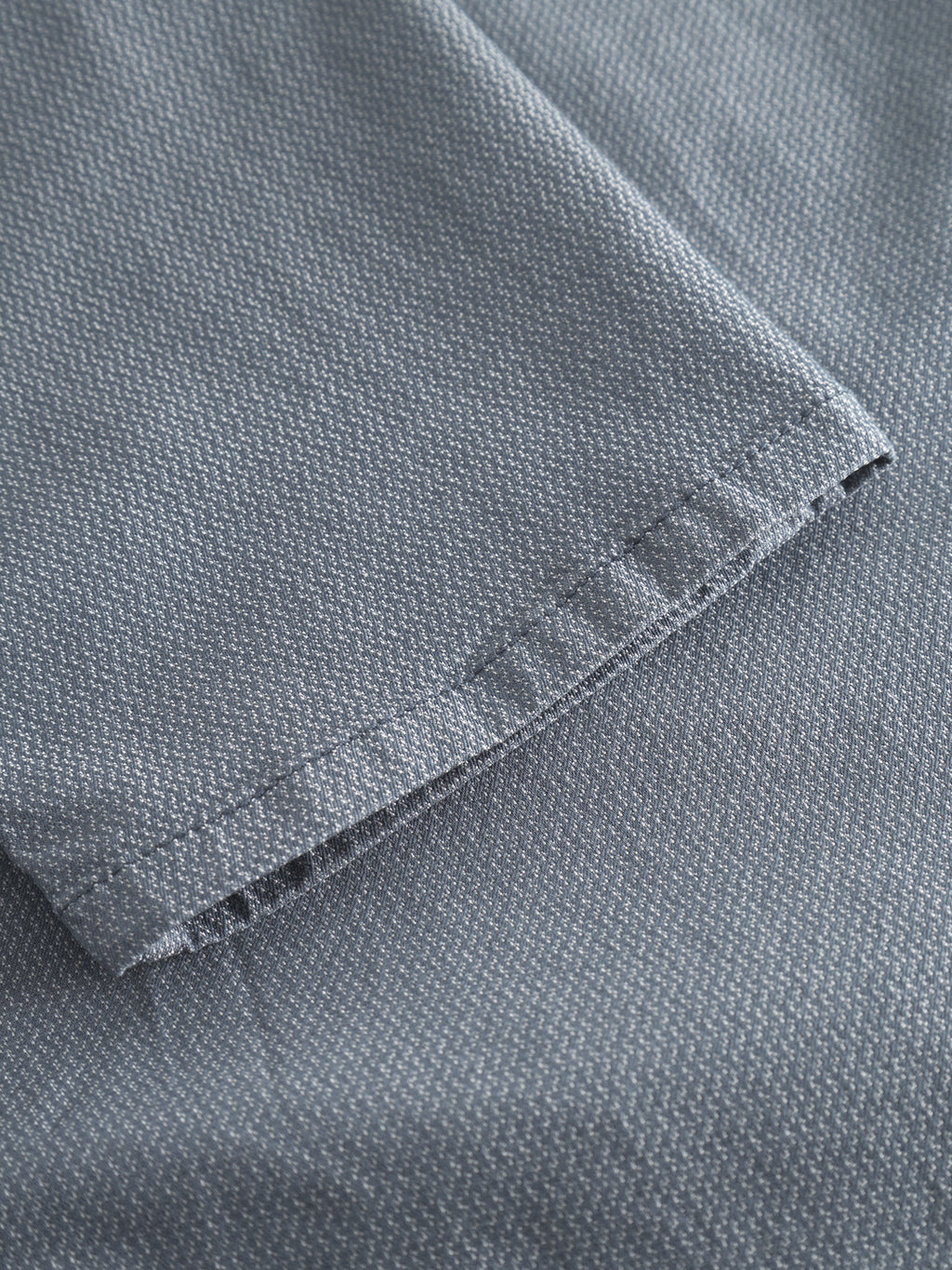 Close-up of the edge of the blue Paul K3280 Dale Chino by Gabba, featuring a slim fit, subtle dotted texture, neat hem stitching, and classic French pockets.