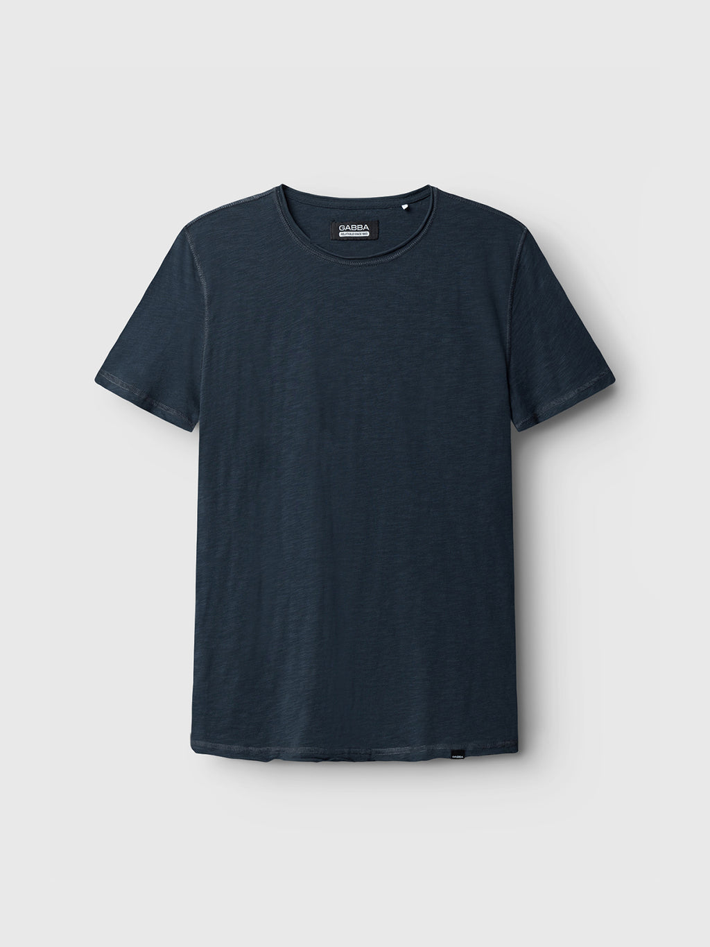 The GABBA Konrad Straight Slub Tee in navy is shown on a light grey backdrop. Made from cotton slub yarn, it has a round neckline and short sleeves, presenting a casual style with its simple, classic design.