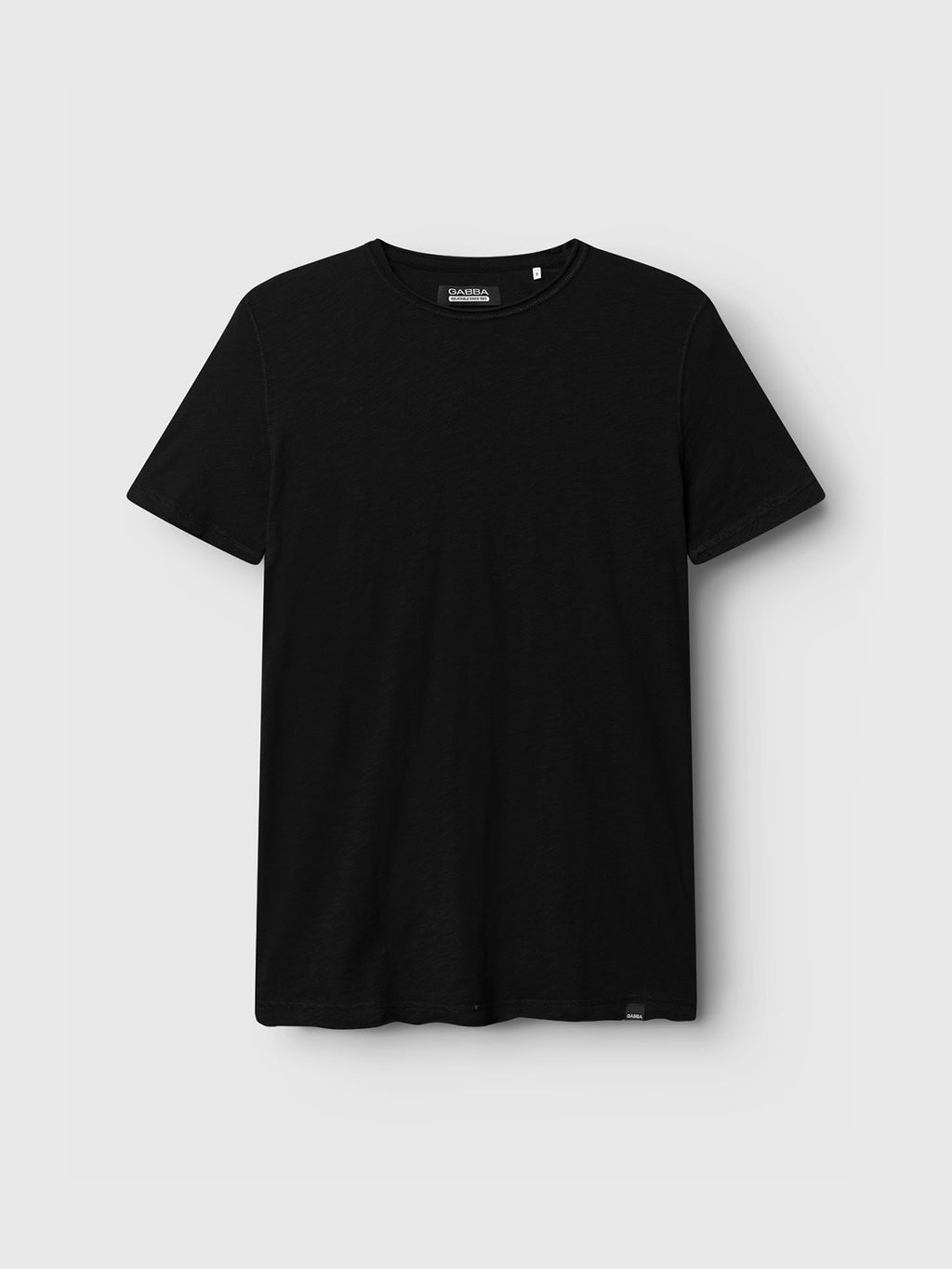 The Konrad Straight Slub Tee by GABBA is a plain black T-shirt made from cotton slub yarn, featuring short sleeves and a round neckline, set against a light grey background. This basic tee provides a regular fit for timeless comfort.