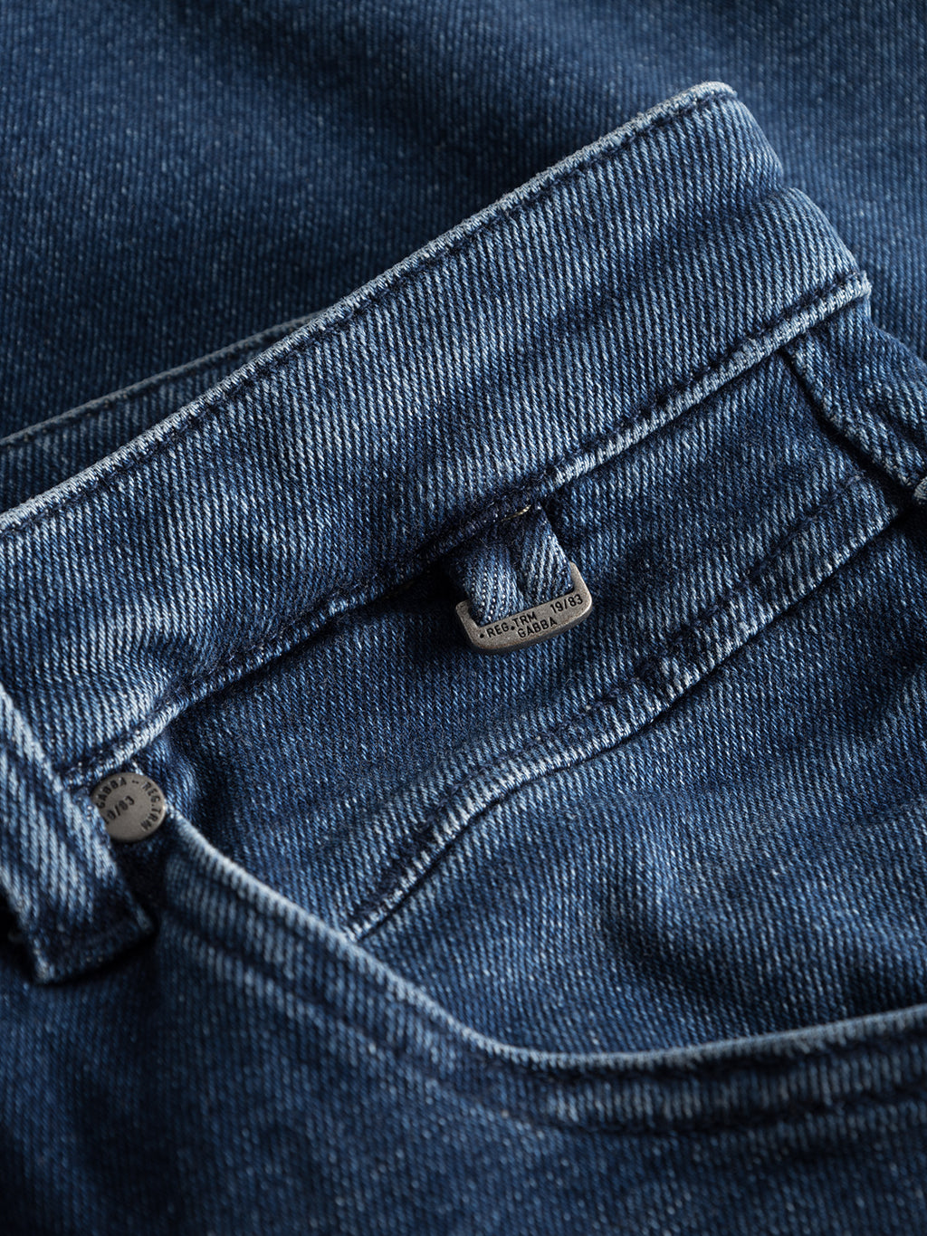 Close-up of GABBAs Alex K3868 jeans in denim wash showcases detailed stitching and texture for a trendy look. A small metal button with the brand name appears near the waistline, accentuating the casual style.