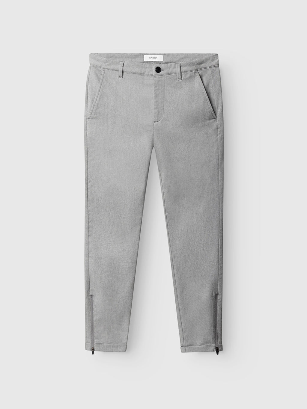 The Gabba Pisa Domo Pants - Monument are slim-fit, light gray trousers in a high-stretch cotton blend, with side and back pockets, button-zipper closure, and zippered ankle cuffs. Shown on a plain white background.