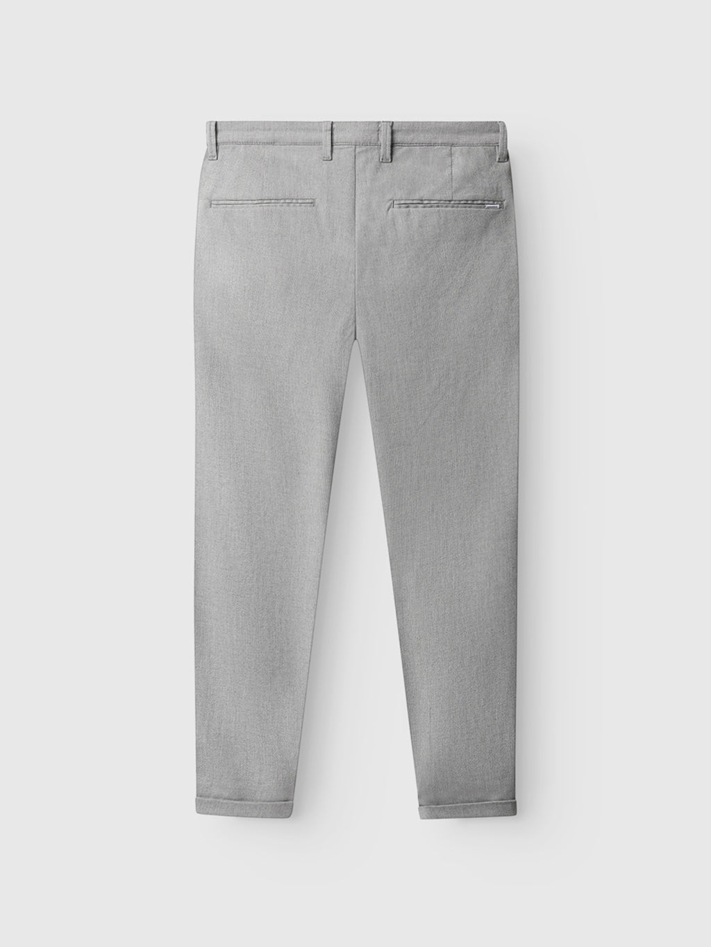 The Gabba Pisa Domo Pants in Monument are light gray, shown from the back with two welt pockets, belt loops, and a tailored fit that tapers at the ankle. Made from high-stretch cotton-blend fabric for comfort. Displayed on a plain white background.