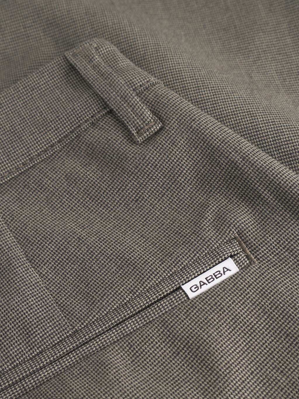 Close-up of gray textured Pisa Domo Pants - SS25Army by Gabba, featuring a metro style with a belt loop, pocket, and a small white Gabba label stitched above the pocket.