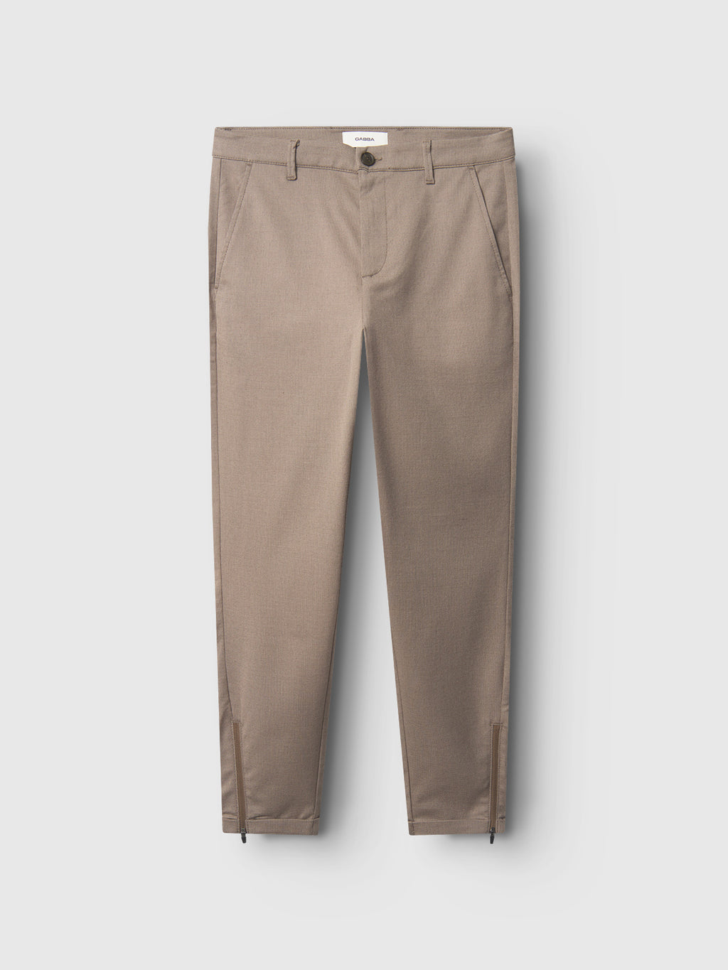 Gabba Pisa Domo Pants in khaki, crafted from high-stretch cotton-blend. Tailored metro style with front pockets, belt loops, button closure, and ankle zippers. Shown flat on a light background.