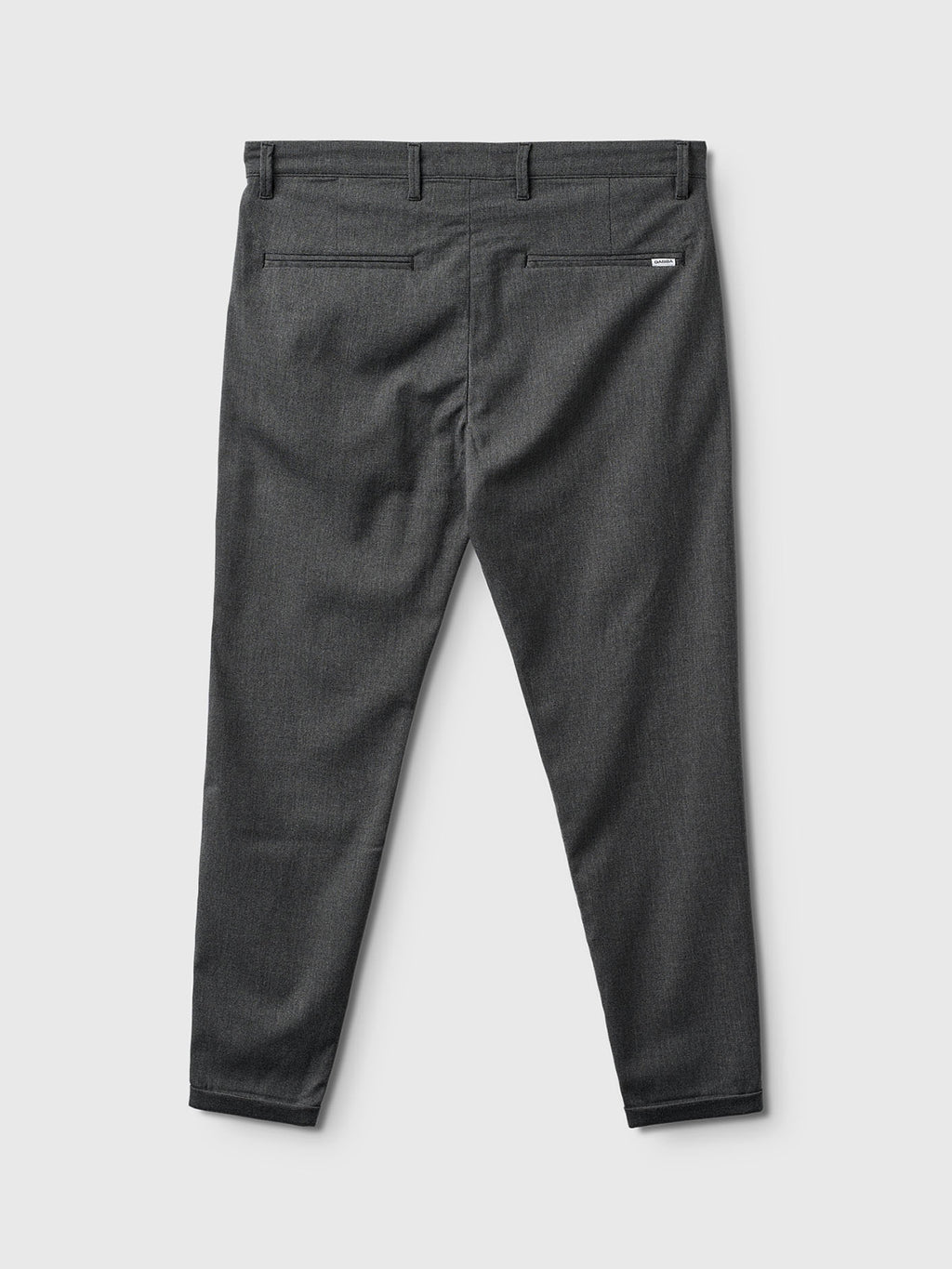 Back view of Gabba Pisa Domo Pants in dark grey, featuring belt loops, two back pockets, and a subtle tag above the right pocket for a modern metro look against a plain light background.